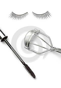 Fake false eyelash with eyelash curler and mascara on white