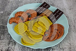 Fake food in a blue plate on a white background