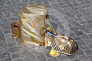 Fake golden mask pharaoh lies on pavement