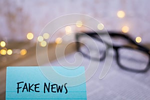 Fake News concept with words on handheld paper