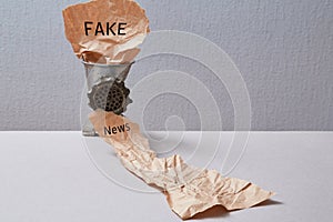 Fake news, disinformation or false information and propaganda concept. Meat grinder and crumpled paper