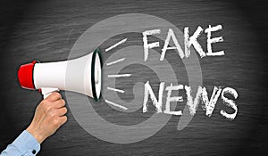 Fake News - Megaphone with hand and text