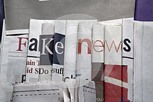 Fake news on newspapers background