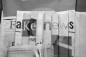 Fake news on newspapers black and white background