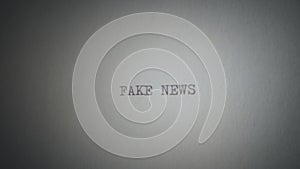 Fake news printed with a typewriter on a piece of paper, captured on a shaking camera.