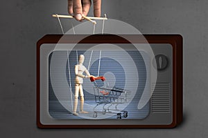 Fake News on TV. Control over the behavior of the buyer. Man with shopping trolley from the supermarket like doll by puppeteer.