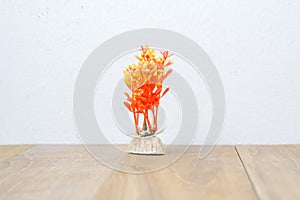 Fake plastic coral on wooden board
