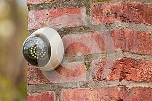 Fake security camera on the wall outside. security camera on a brick pillar in the yard