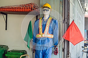 Fake traffic mannequin in the clothes of a road worker