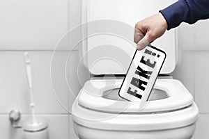 fake word on the smartphone screen a person throws a smartphone phone with news on the screen into the toilet. Refusal