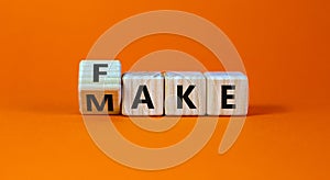 Fake it until you make it symbol. Turned a cube and changed the word `fake` to `make`. Beautiful orange background. Business,