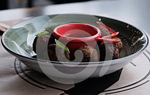 Falafel balls with parsley in wooden bowl with tahini sauce