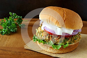 Falafel burger with lettuce, tomato, onion and tzatziki sauce