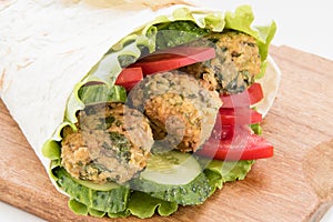 Falafel and fresh vegetables rolled in pita bread