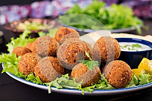 Falafel, hummus and pita. Middle eastern or arabic dishes on a dark background.