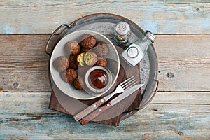 Falafel plate with spice and souce on metal tray