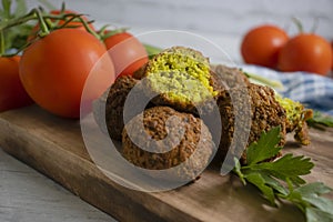 Falafel, tomatoes  gourmet  homemade  veggies  cooking  on a wooden background nutrition