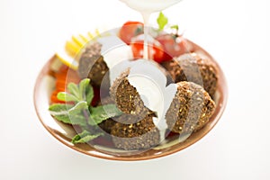 Falafel topped with tahini sauce