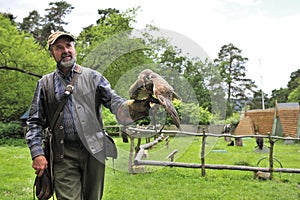 Falconer with Falcon falco cherrug .