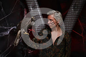 Falconer holding Sea Eagle on glove. man in a military uniform with a fighting large bird of prey on his arm