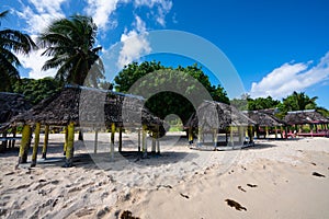 Fale`s on a white sand beach at Lalomanu, Samoa