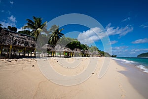 Fale`s on a white sand beach at Lalomanu, Samoa