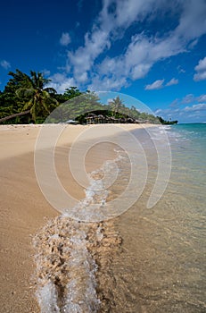 Fale`s on a white sand beach at Lalomanu, Samoa