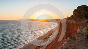 Falesia Beach seen from the cliff at sunset photo