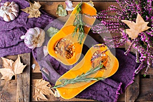 Fall autumn harvest background with butternut squash pumpkin and rosemary