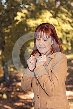 Fall. Autumn Park. Autumnal Trees and Leaves in sun rays. redhead woman have fun in the autumn forest