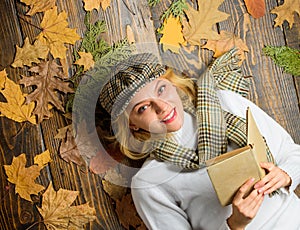 Fall and autumn season. Woman lady in checkered hat and scarf read book. She likes detective genre. Girl in vintage