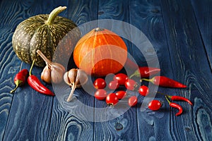 Fall background with pumpkins on blue wooden background with cop