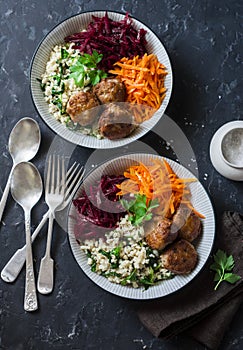 Fall buddha bowl. Bulgur, spinach, meatballs, beets, carrots - balanced healthy eating lunch. On a dark background, top view