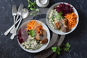 Fall buddha bowl. Bulgur, spinach, meatballs, beets, carrots - balanced healthy eating lunch. On a dark background, top view.