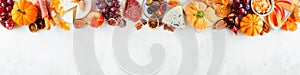 Fall charcuterie top border against a white marble banner background photo
