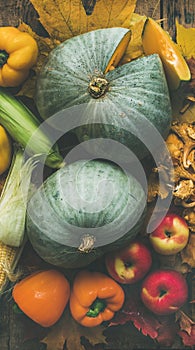 Fall colorful vegetables assortment over wooden table background. Food texture