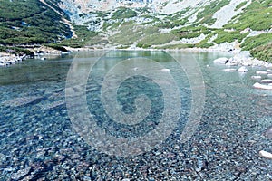 Fall colors reflected in a lagoon in the High Tatras