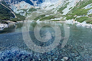 Fall colors reflected in a lagoon in the High Tatras