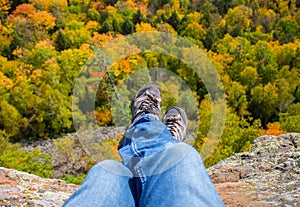 Fall colors seen from above in this POV perspective, including a personâ€™s legs.