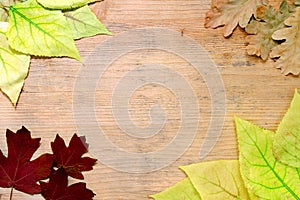 Fall composition - frame of yellow and red leaves on a wooden background. Copy space. Autumn background