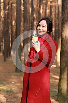 Fall concept - autumn woman drinking coffee