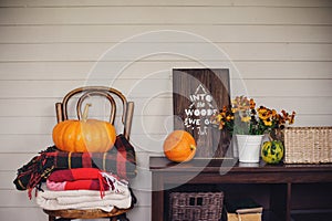 Fall at country house. Seasonal rustic decorations with cozy blankets and flowers