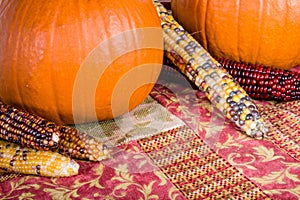 Fall display of orange pumpkins and corn