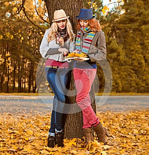 Fall Fashion. Friends Woman walk in Autumn park