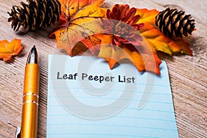 Fall Foliage Leaf Peeper concept on notebook and wooden board