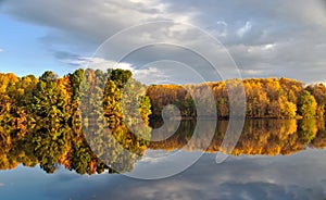 Fall foliage reflected in still water