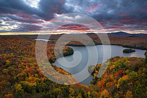 Colorful cloudy sunset over Nichols Pond in autumn photo