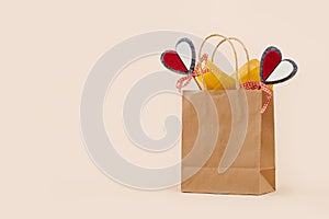 Fall Gift or Sale concept. Shopping paper bag, heart tag autumn decor.