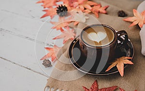 Fall harvest cornucopia. Cup of Hot apple tea for Autumn season warm drink. on wood background