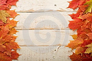 Fall leaves frame on whooden background